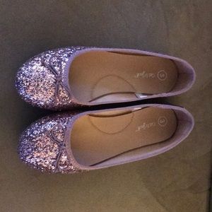 Pink/champagne color sparkly shoes.